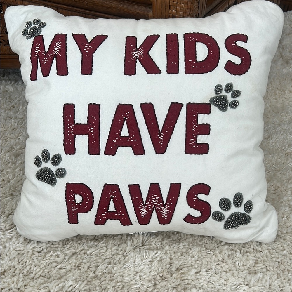 White Pillow with Red Text and Paw Prints